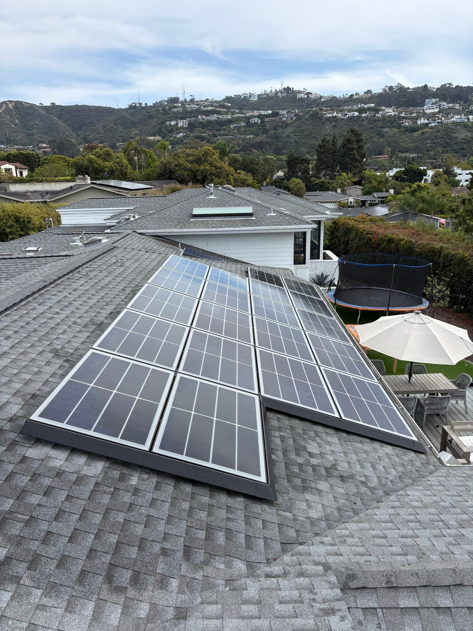 Rooftop solar array and shingle roof cleaned with soft washing in El Cajon