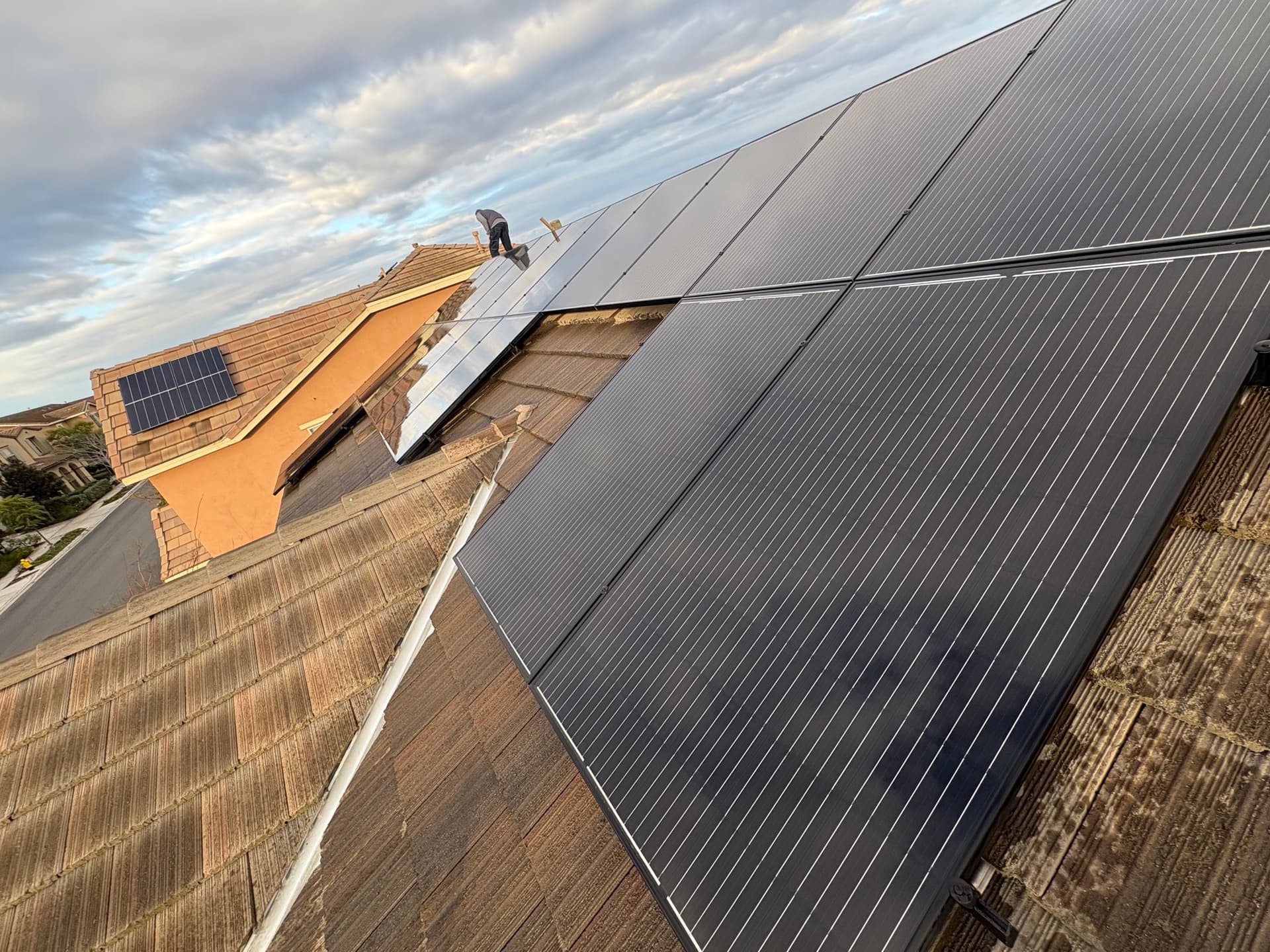 Buxton Window Cleaning crew member working across rooftop solar panels in El Cajon