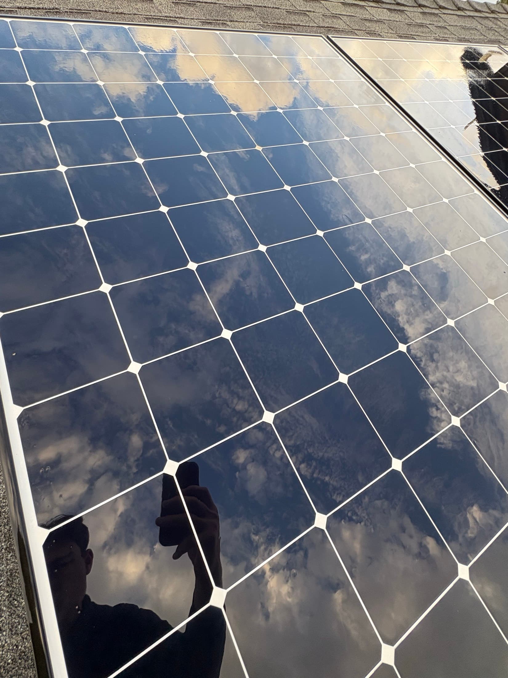 Detail of freshly cleaned solar panel glass reflecting the sky