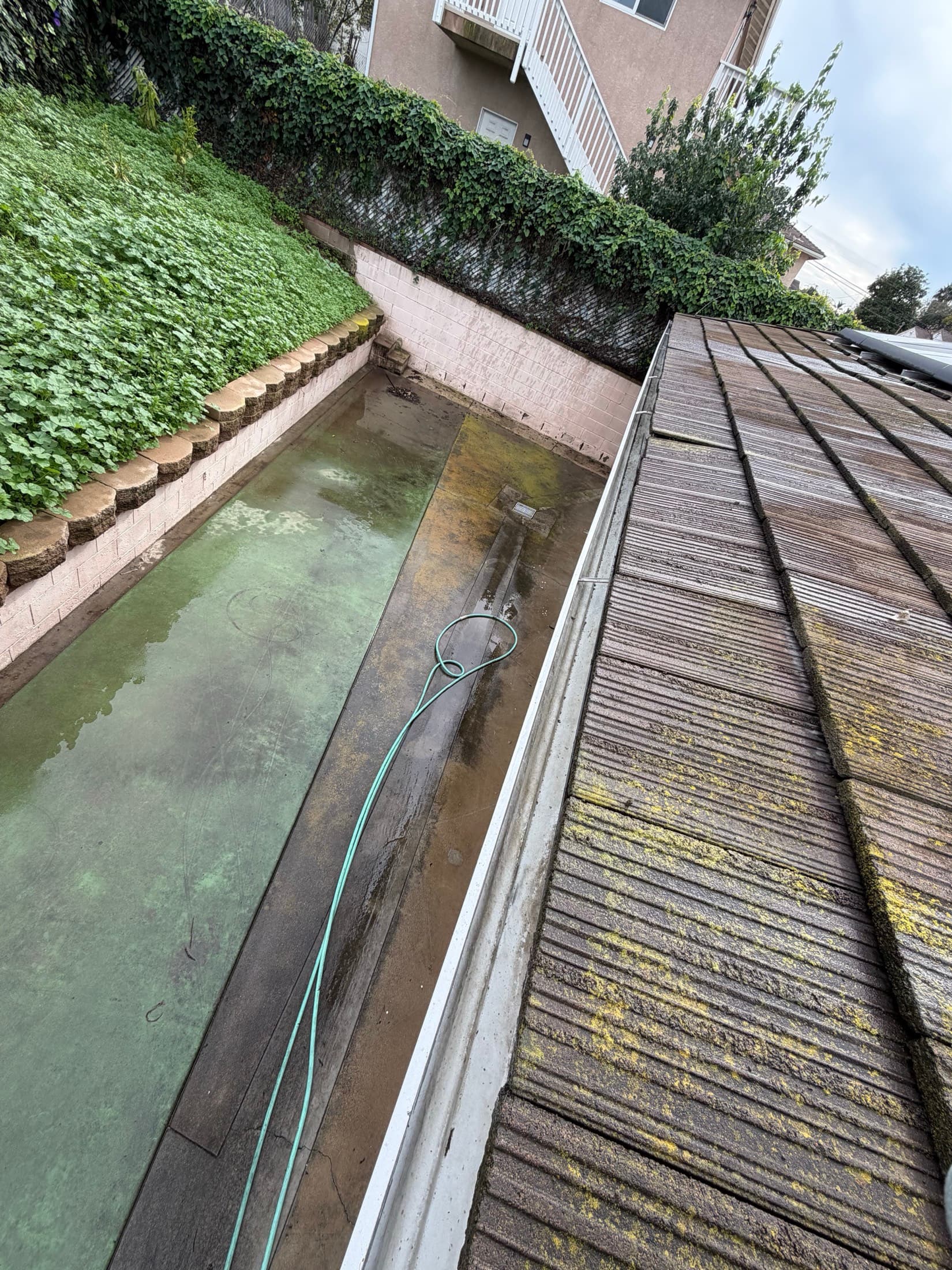 Roof line and patio surfaces before pressure washing in El Cajon