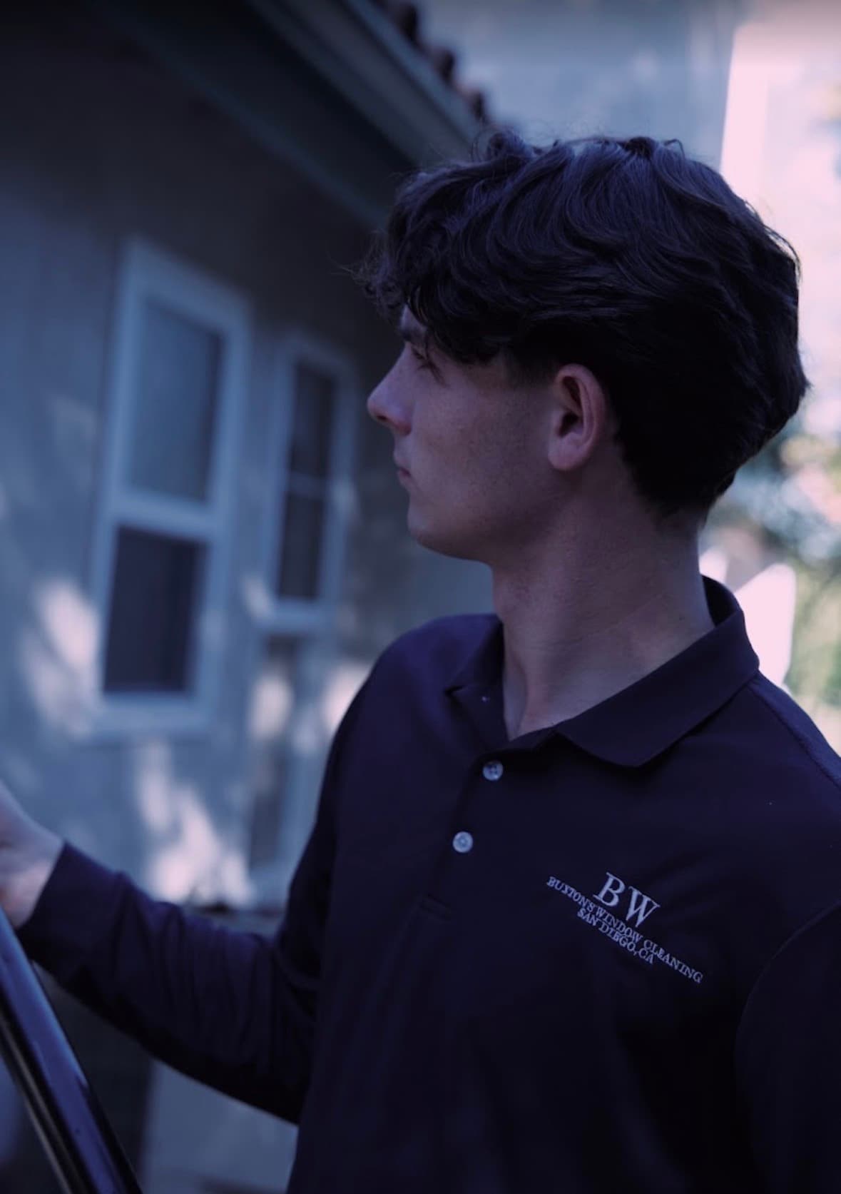Buxton Window Cleaning technician in uniform on a window cleaning job in El Cajon